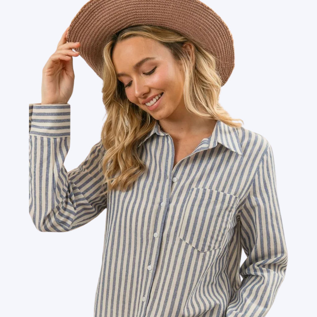 woman wearing BiBi striped button-up shirt with long sleeves and straw hat