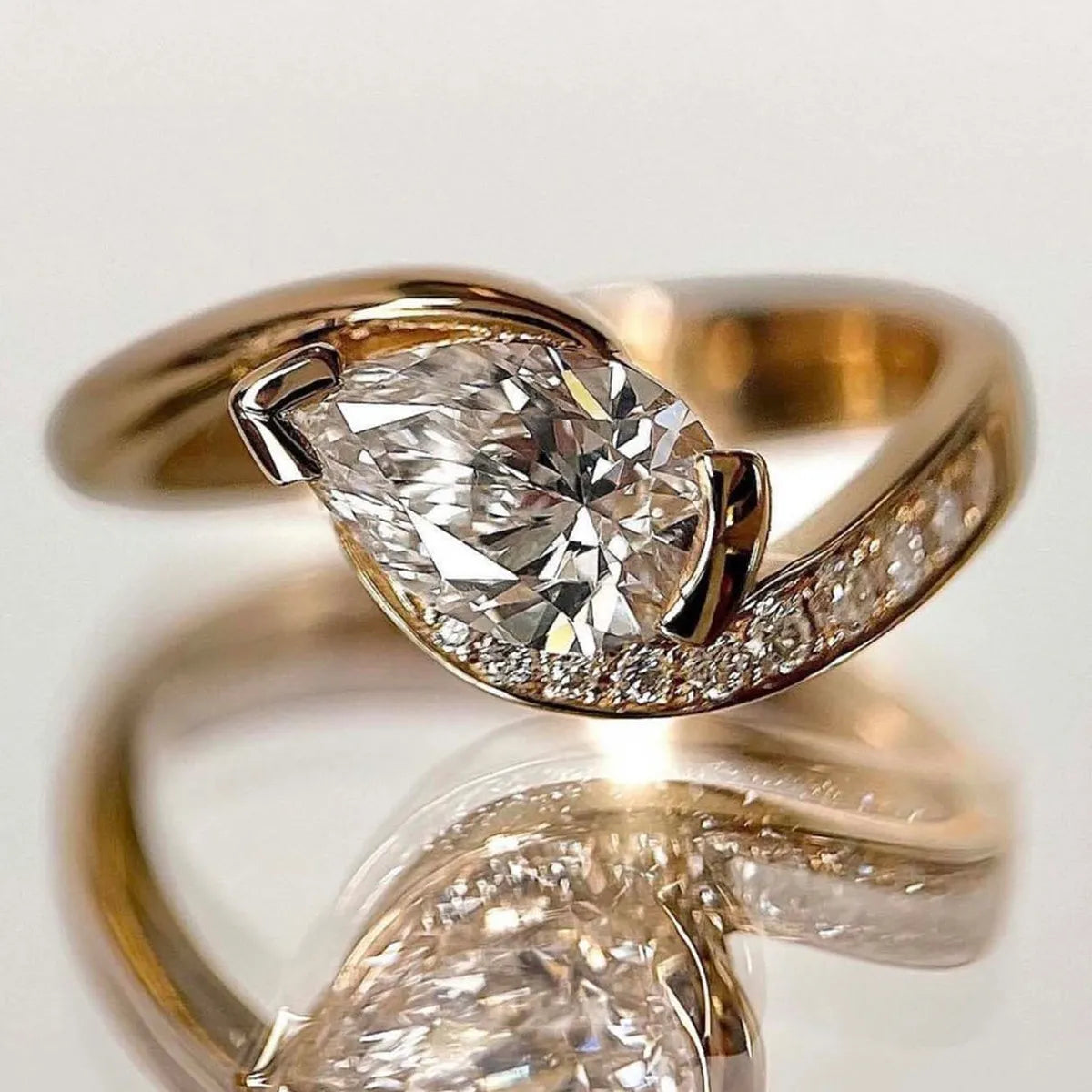 Close-up of Donjane! 1.5ct Moissanite Ring – pear-shaped stone with gold-plated sterling silver setting