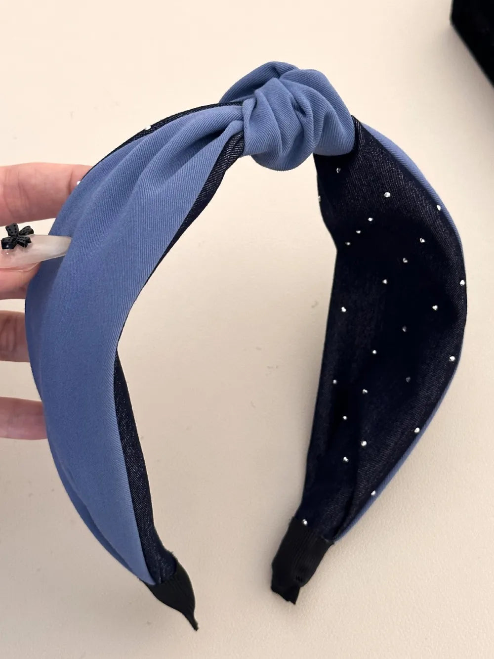 close-up of blue polyester headband with knot detail