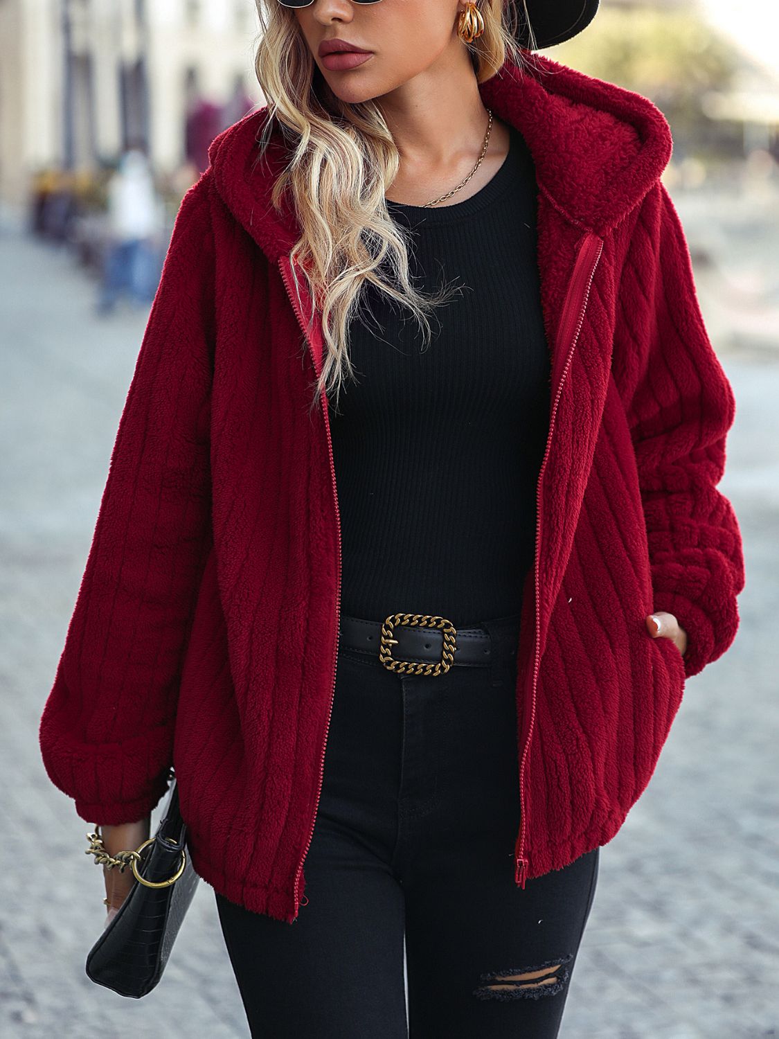belted winter jacket for women layered over knits