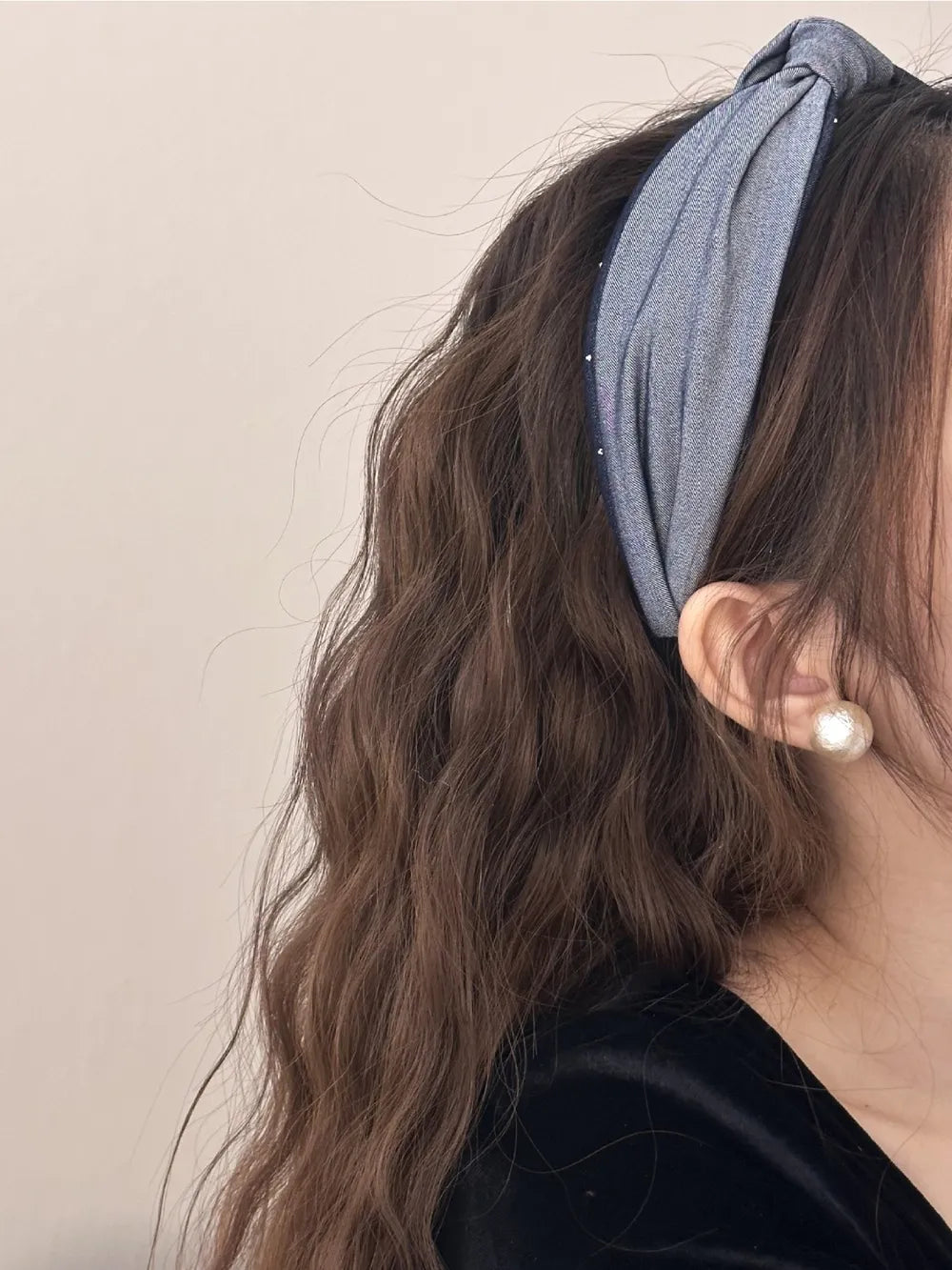 side view of woman styling grey and blue wide headband