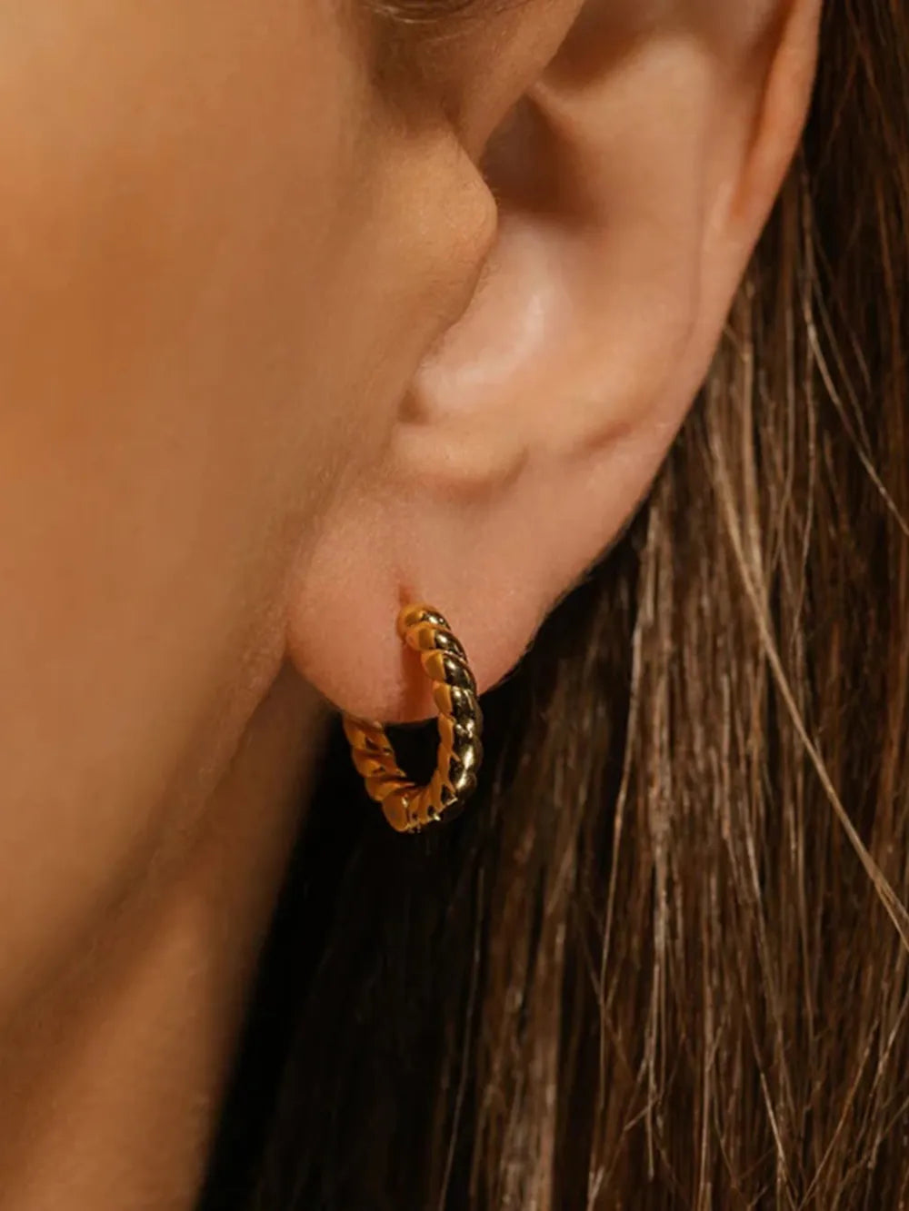 small 18K gold-plated stainless steel stud earrings with 0.4 by 0.5 inch polished finish