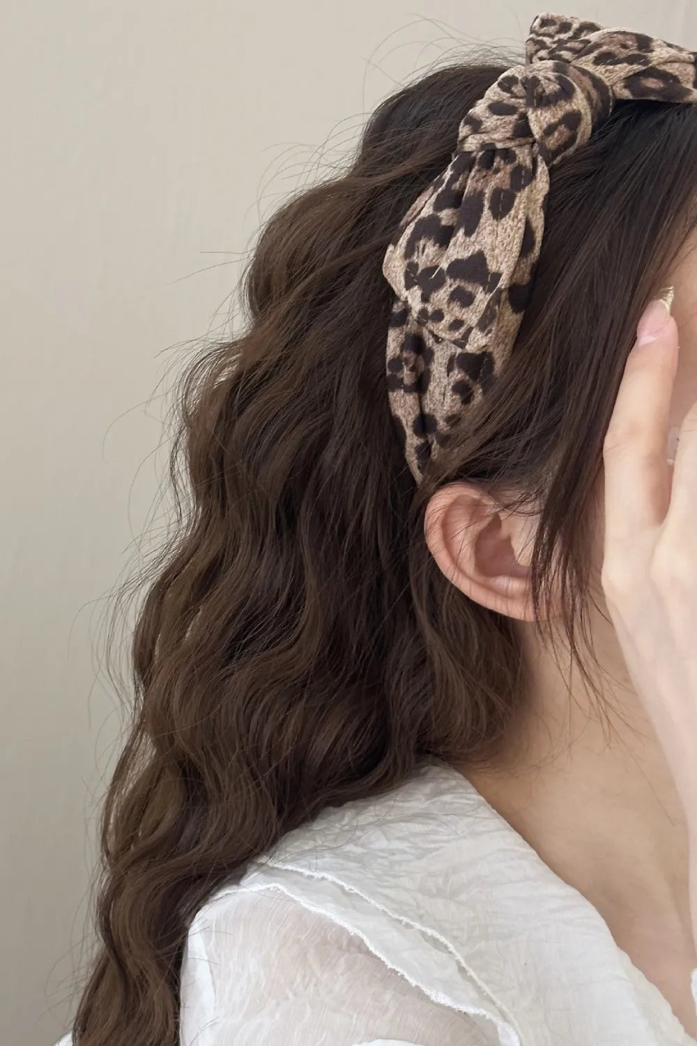 back view of wide leopard print headband on long hair