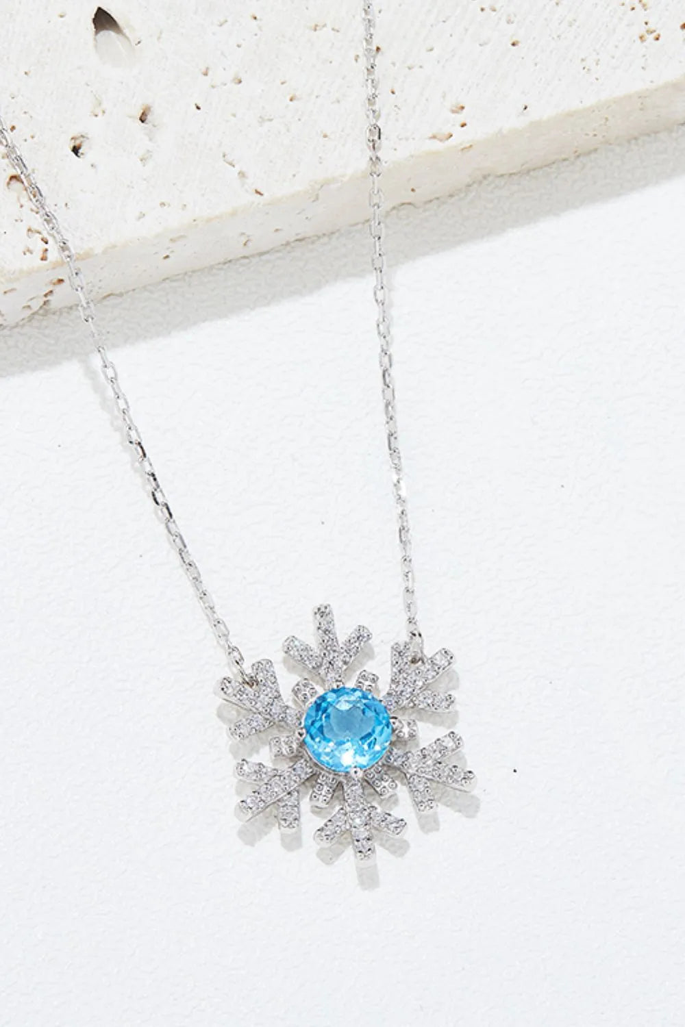 925 sterling silver topaz snowflake shape necklace shown as women’s top