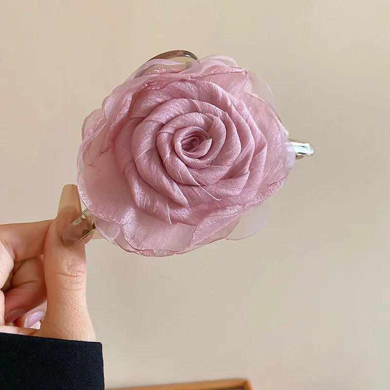 close-up of mauve flower claw clip held in hand