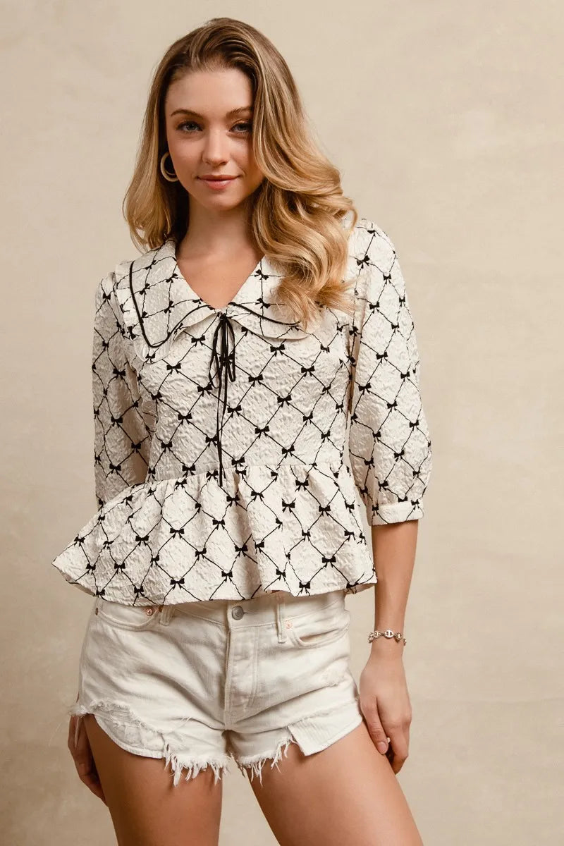 bibi bow prints-patterns ruffle collar details peplum top shown as women’s outerwear