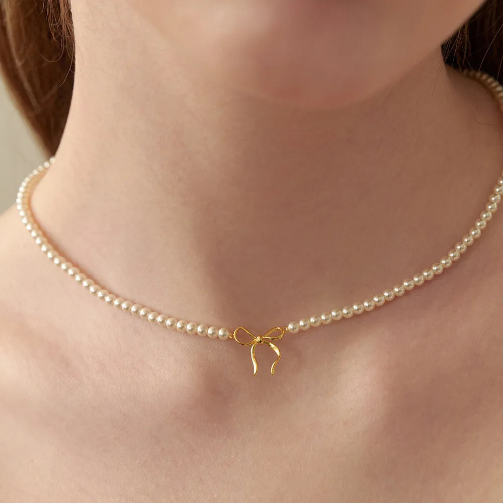 women’s apparel — copper pearls bow necklace