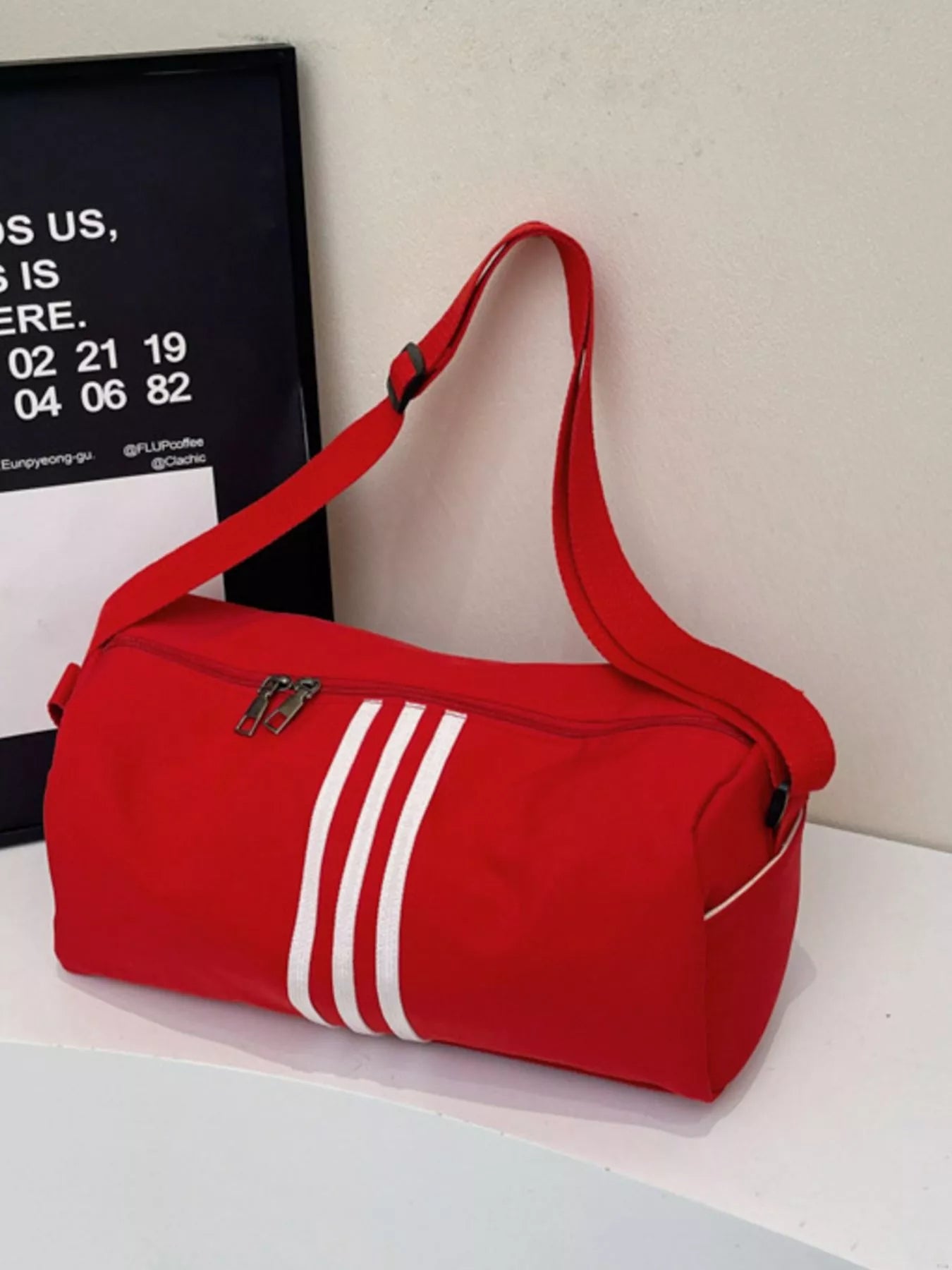 women's striped adjustable strap duffel bag - front view