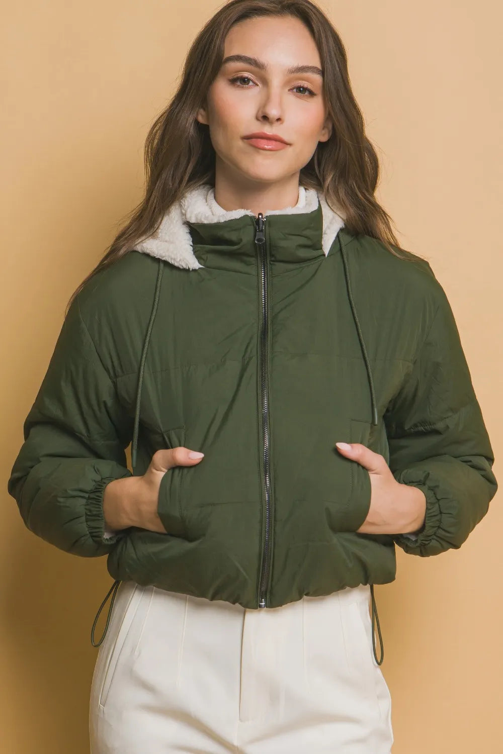 belted winter jacket for women in mountain lodge setting