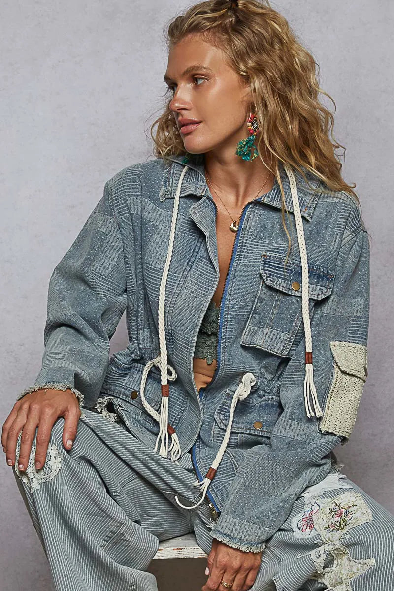 belted outerwear jacket layered over knitwear