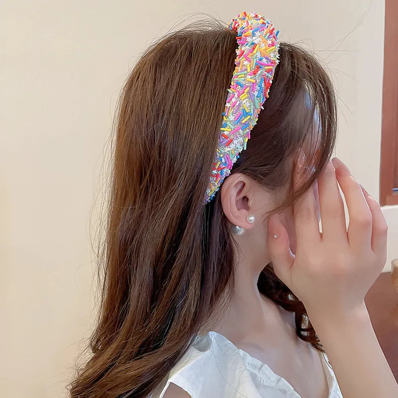 model adjusting wide acrylic headband with bright colors