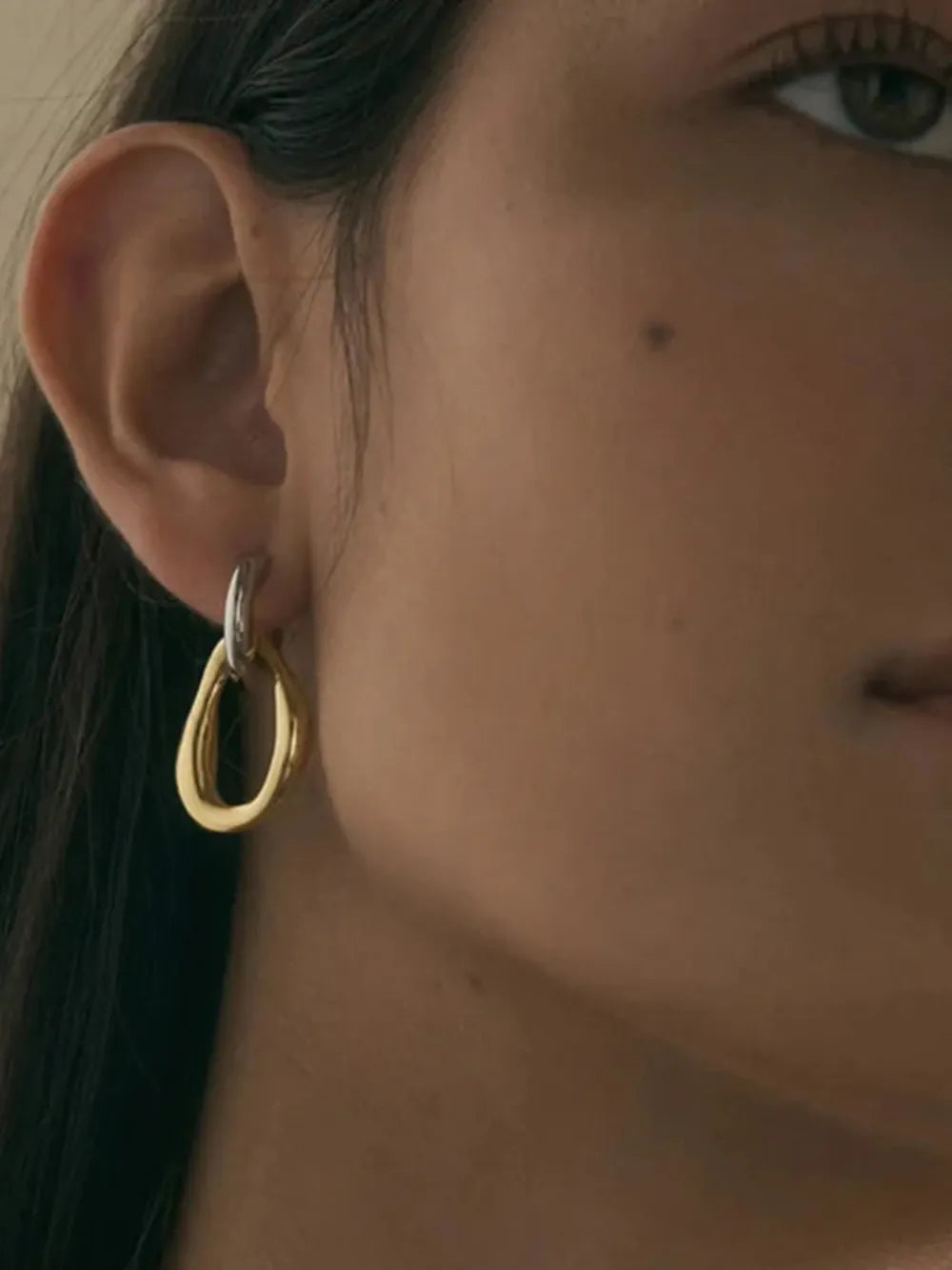 Now on Sale in Donjane : 18K gold-plated stainless steel asymmetrical drop earrings with sculptural contrast design and 1.4 inch length