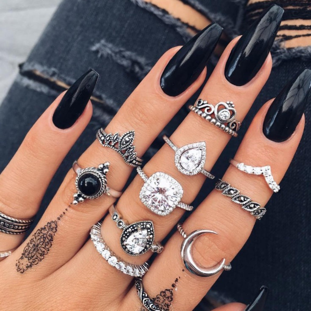 Alloy synthetic crystal 11-piece ring set with mixed metallic finishes, stacked fashion rings from Donjane.

