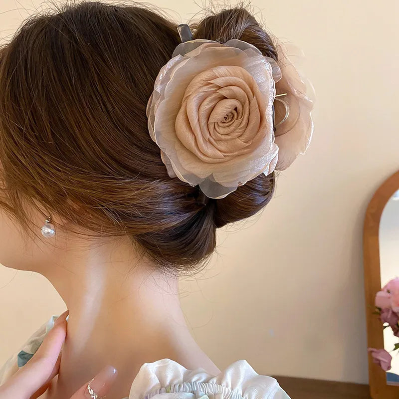soft beige rose-shaped claw clip against neutral background